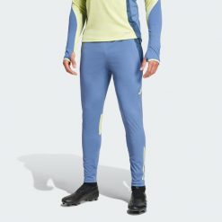 Spodnie Ajax Amsterdam Tiro 24 Competition Training. Niebieskie spodnie dresowe męskie ADIDAS, bez wzorów, z dresówki. Za 299.00 zł.