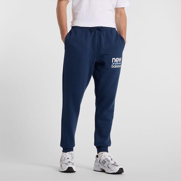 Spodnie męskie New Balance MP51940NNY – granatowe. Niebieskie spodnie dresowe męskie New Balance, bez wzorów, z bawełny. Za 219.99 zł.