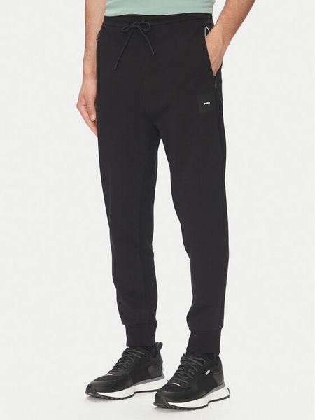 BOSS Spodnie dresowe Hadiko 50537198 Czarny Regular Fit. Czarne spodnie dresowe męskie Boss, bez wzorów, z bawełny. Za 519.99 zł.