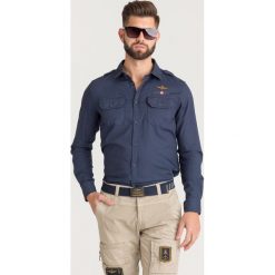 KOSZULA Aeronautica Militare. Niebieskie koszule męskie Aeronautica Militare, l, bez wzorów, z bawełny, bez kołnierzyka, bez ramiączek. Za 569.00 zł.