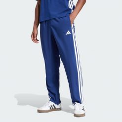 Spodnie Essentials 3-Stripes Stanford Open Hem. Białe długie spodnie sportowe męskie ADIDAS, bez wzorów, z materiału, na fitness i siłownię. W wyprzedaży za 134.25 zł.