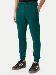 Adidas Spodnie dresowe Essentials Feel Cozy JE3858 Zielony Regular Fit. Zielone spodnie dresowe męskie ADIDAS, bez wzorów, z dresówki. Za 219.99 zł.