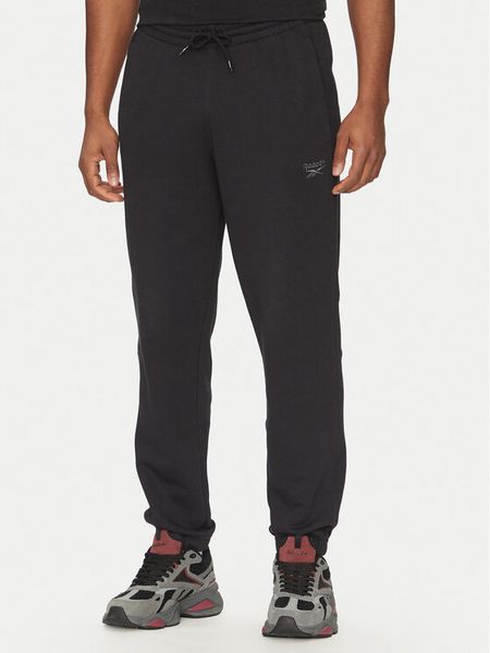 Reebok Spodnie dresowe 100214075 Czarny Regular Fit. Czarne spodnie dresowe męskie Reebok, bez wzorów, z bawełny. Za 219.99 zł.