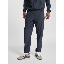 Spodnie dresowe tkane Hummel Pulse. Brązowe spodnie dresowe męskie HUMMEL, bez wzorów, z dresówki. Za 239.50 zł.